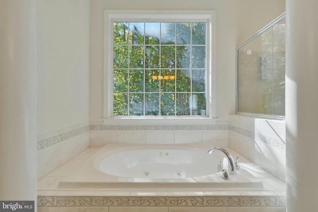 bathroom featuring tiled tub