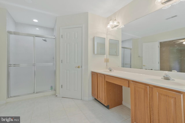 bathroom featuring vanity and an enclosed shower