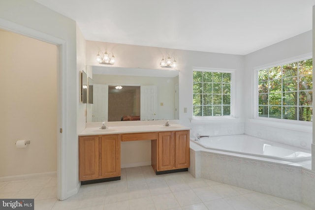 bathroom with tile patterned floors, tiled bath, vanity, and a chandelier