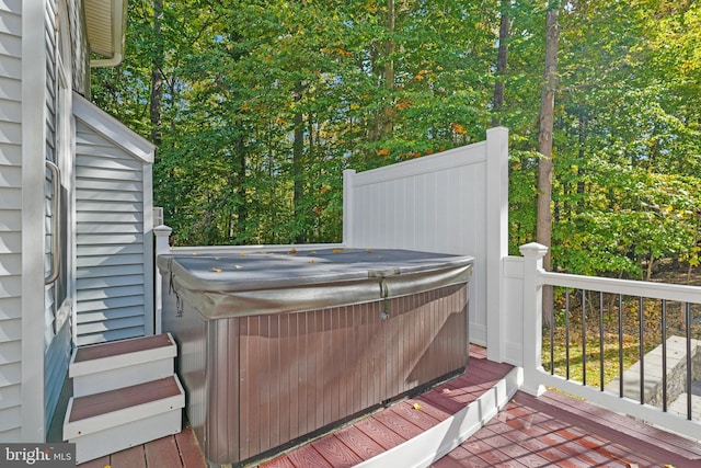 wooden deck with a hot tub