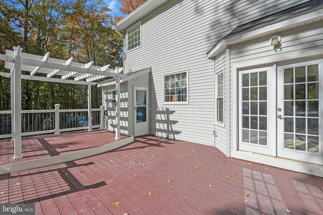 deck featuring french doors and a pergola