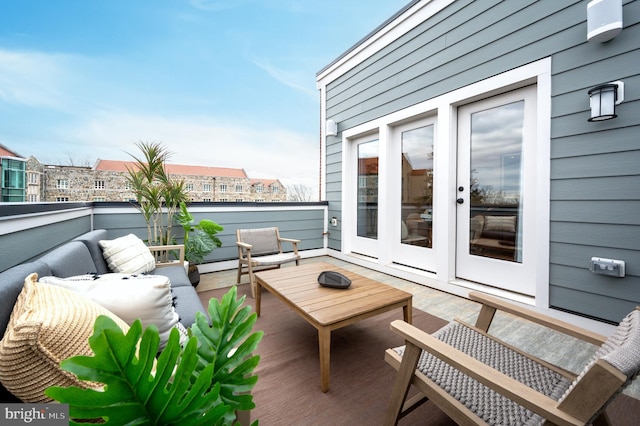 balcony with an outdoor living space and a baseboard radiator