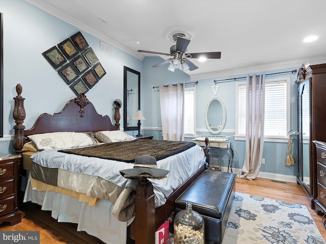 bedroom featuring crown molding, ceiling fan, and light wood-type flooring