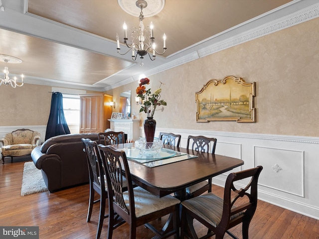 dining area with crown molding, dark hardwood / wood-style flooring, and a chandelier