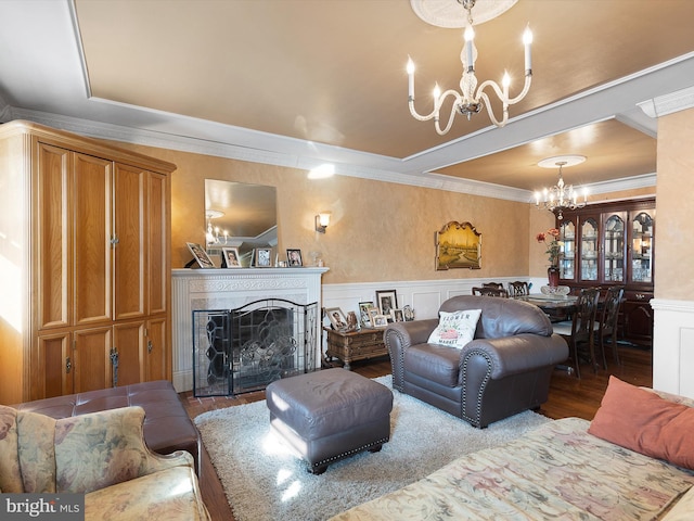 living room featuring hardwood / wood-style flooring, ornamental molding, and a notable chandelier