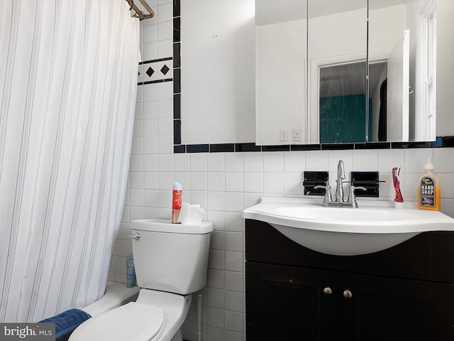 full bathroom featuring vanity, tile walls, shower / bath combination with curtain, and toilet