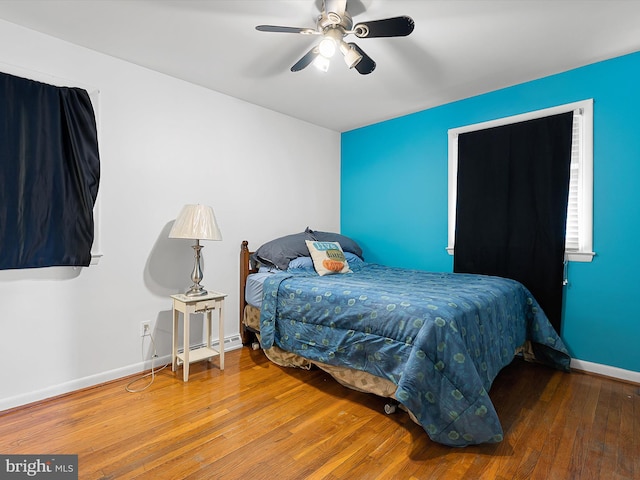 bedroom featuring wood-type flooring and ceiling fan