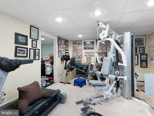 workout room with carpet and a drop ceiling