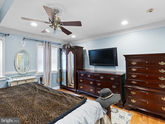 bedroom featuring crown molding, ceiling fan, and light hardwood / wood-style floors