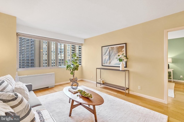 living room with radiator heating unit and light wood-type flooring