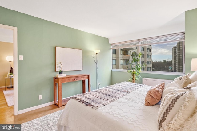 bedroom with hardwood / wood-style flooring