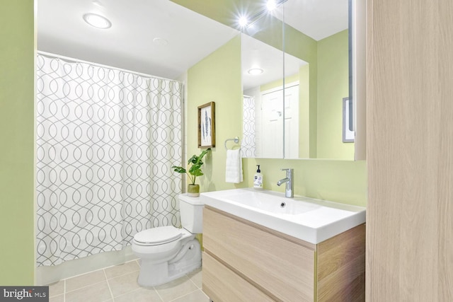 bathroom featuring a shower with shower curtain, tile patterned floors, vanity, and toilet