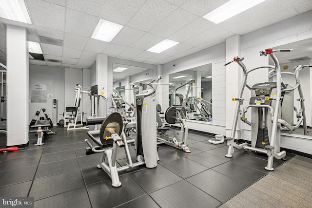 exercise room featuring a drop ceiling