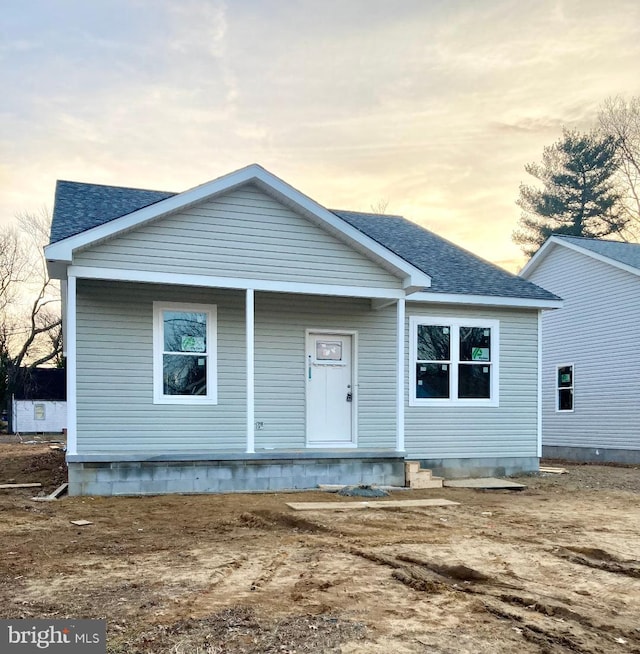 view of front of property featuring crawl space and a shingled roof