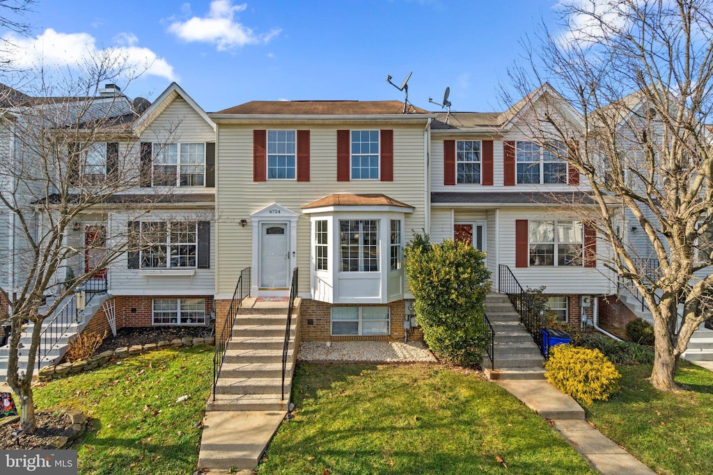 view of property featuring a front yard