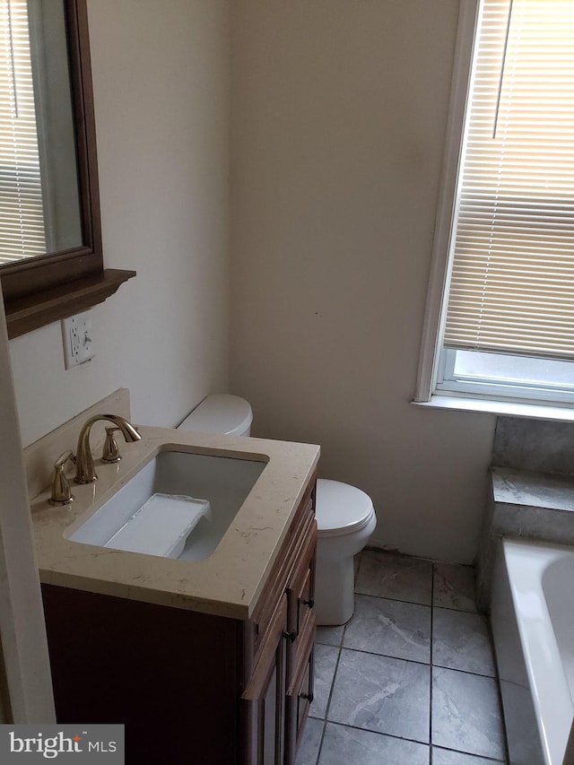 full bath with toilet, a tub, and vanity