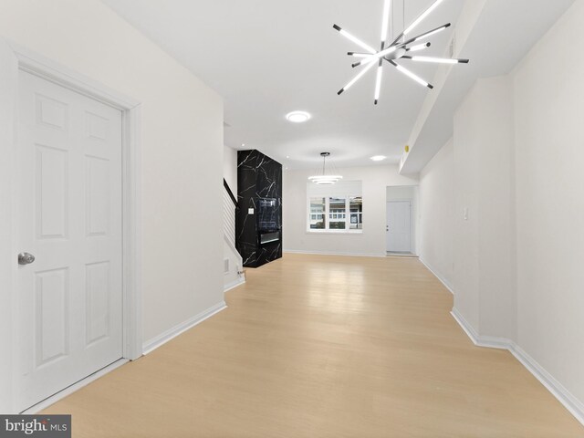 interior space with a chandelier and light hardwood / wood-style floors