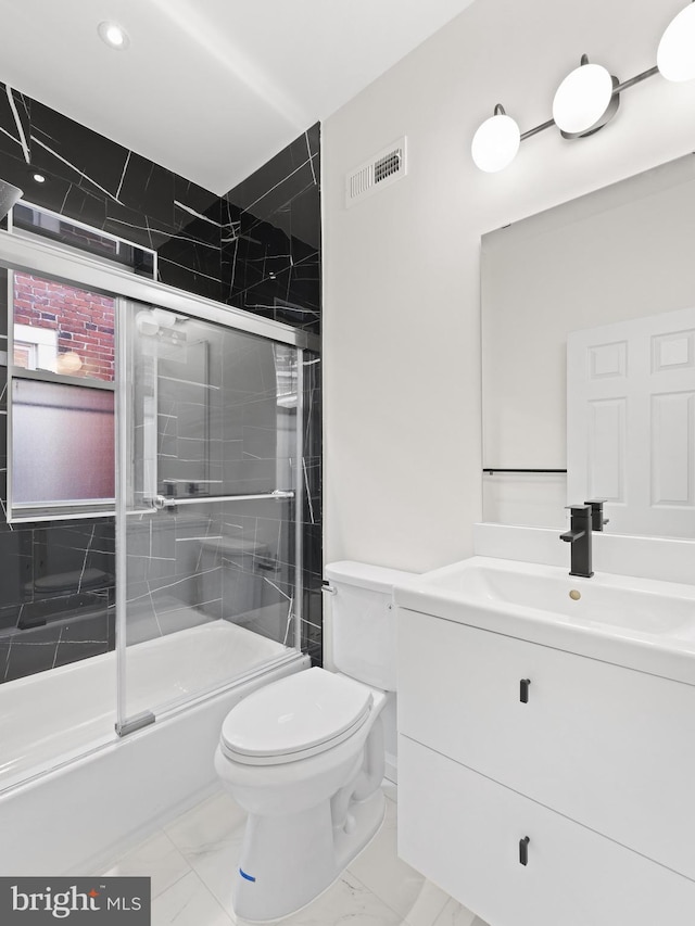 full bathroom featuring vanity, toilet, and enclosed tub / shower combo