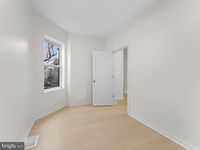 spare room featuring light wood-type flooring