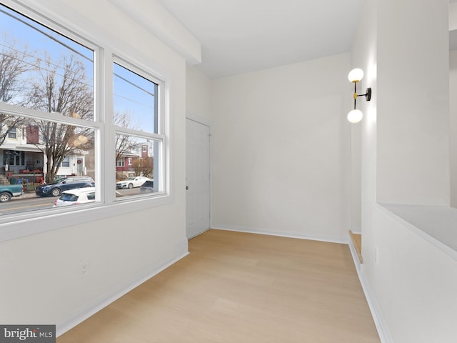 spare room featuring light wood-type flooring and a wealth of natural light