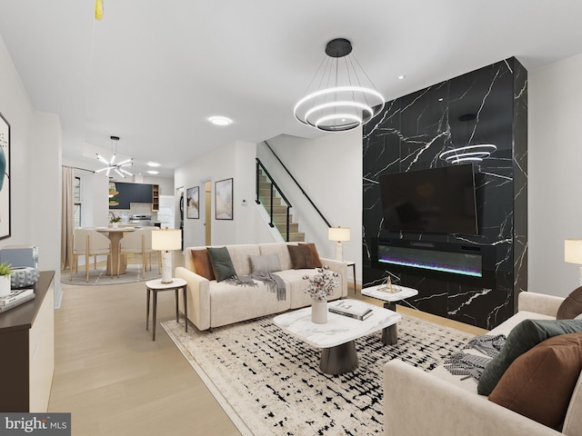 living room with a chandelier and light hardwood / wood-style flooring