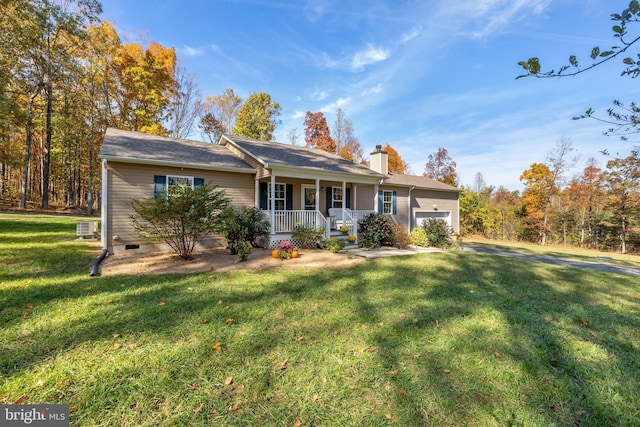 ranch-style home with covered porch, a garage, central AC unit, and a front yard