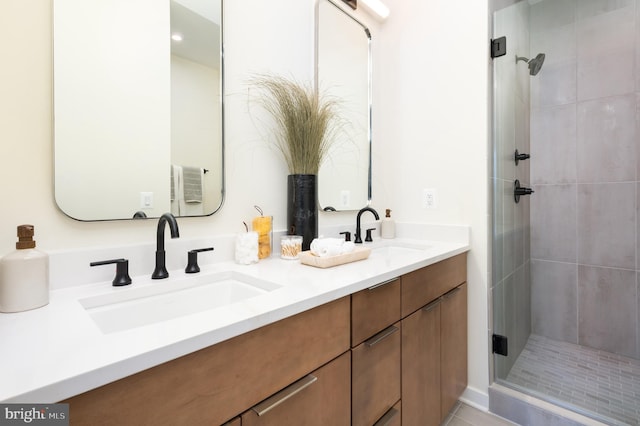 bathroom featuring vanity and an enclosed shower