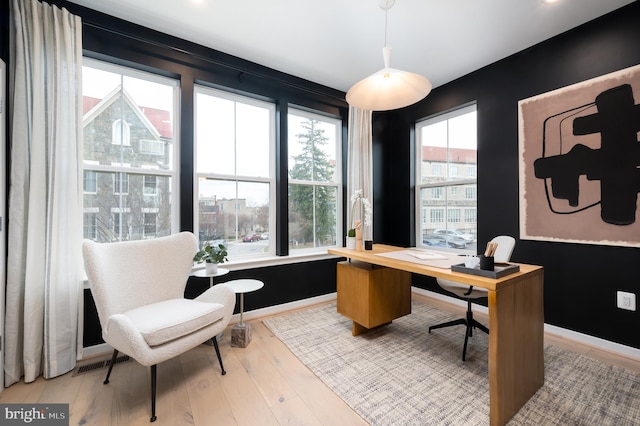 office space with wood-type flooring