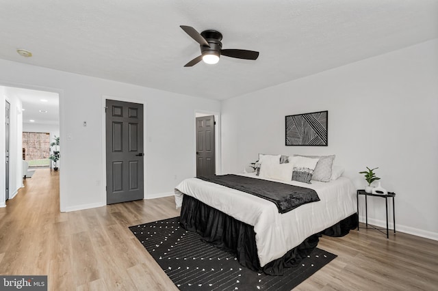 bedroom with hardwood / wood-style floors and ceiling fan