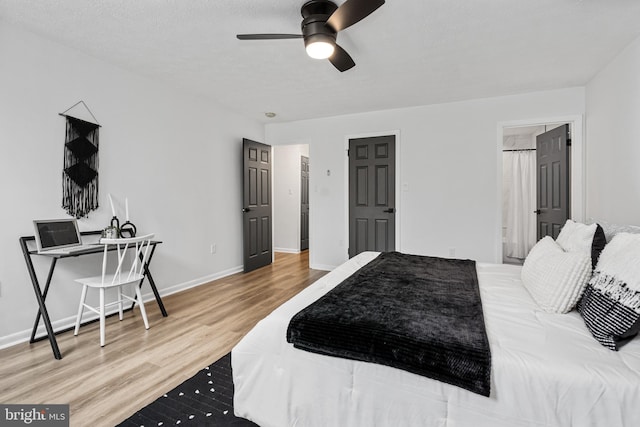 bedroom with ceiling fan, wood-type flooring, and ensuite bathroom