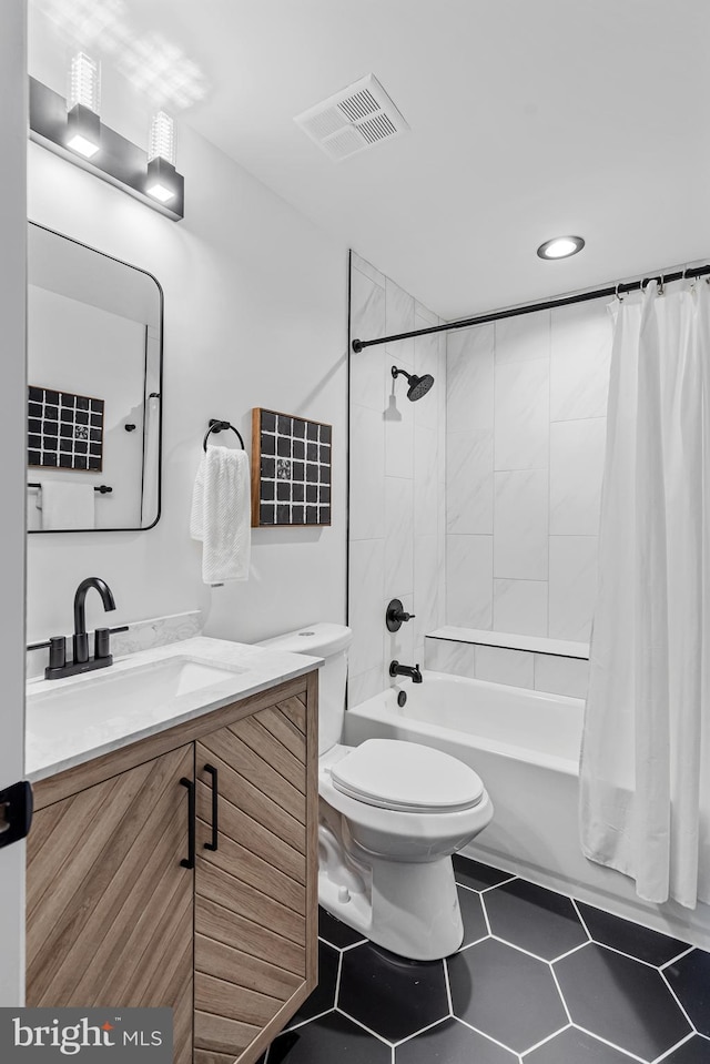 full bathroom featuring shower / tub combo with curtain, vanity, toilet, and tile patterned floors