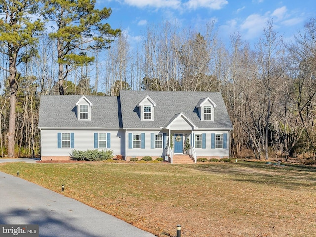 cape cod house featuring a front yard