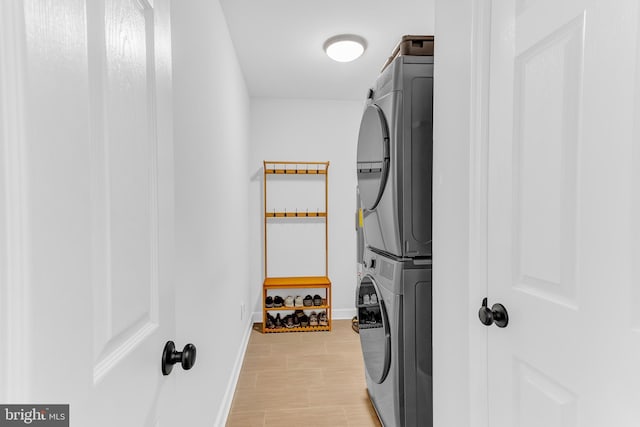 clothes washing area with stacked washer / dryer