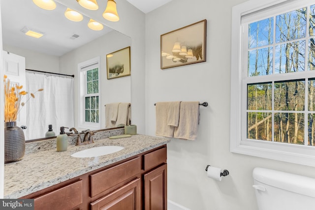 bathroom featuring vanity and toilet