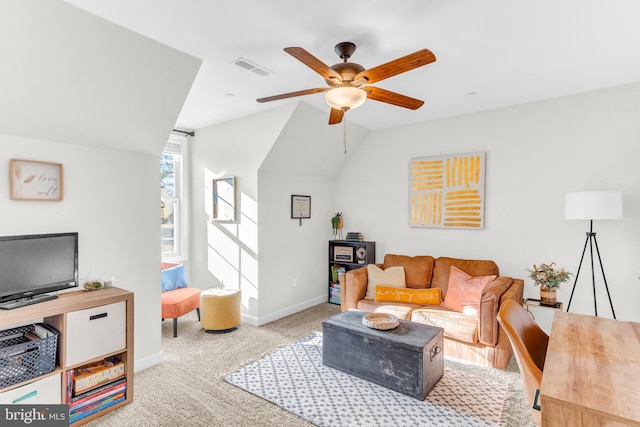 carpeted living room with ceiling fan and vaulted ceiling