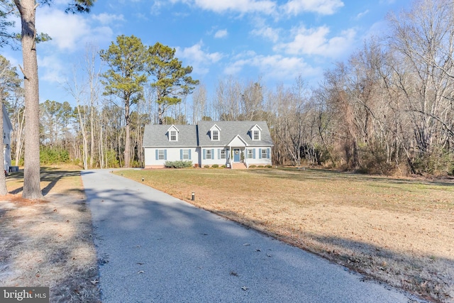 cape cod home with a front yard