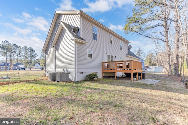 back of house with central AC unit, a lawn, and a wooden deck