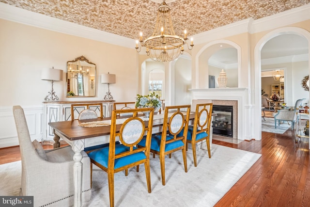 dining room featuring wood-type flooring, ornamental molding, brick ceiling, and an inviting chandelier