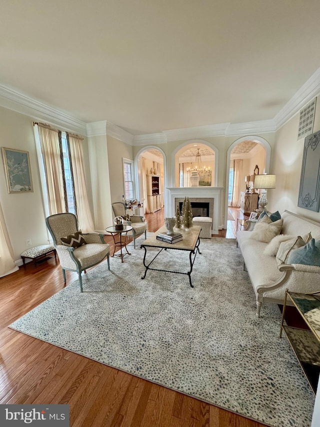 living room with wood-type flooring and ornamental molding