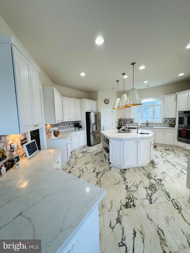 kitchen featuring white cabinetry, a center island, tasteful backsplash, high end refrigerator, and decorative light fixtures