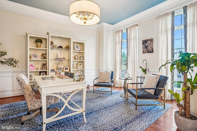 office with hardwood / wood-style floors, a notable chandelier, and ornamental molding