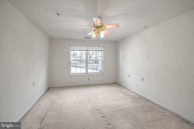 unfurnished room featuring ceiling fan and light colored carpet