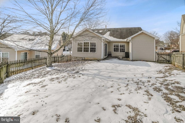 view of snow covered back of property