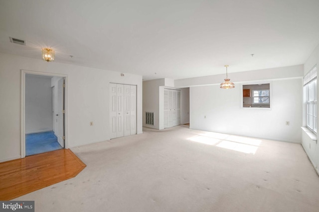 unfurnished living room with light carpet