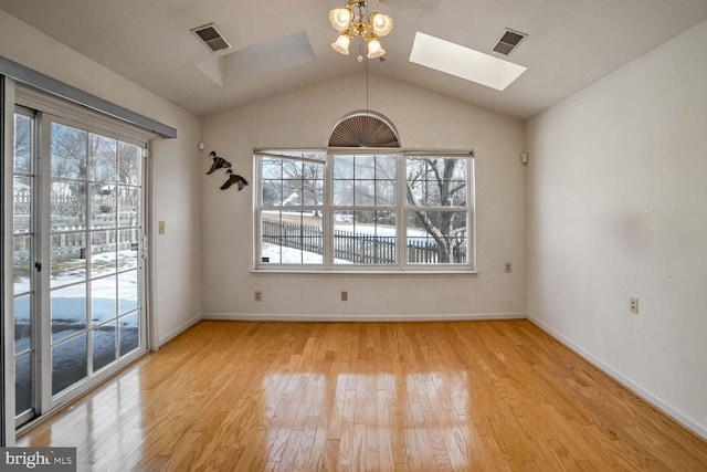 unfurnished dining area featuring lofted ceiling with skylight, a wealth of natural light, and light hardwood / wood-style floors