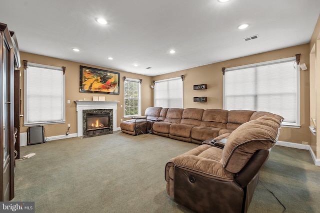 carpeted living room with a fireplace