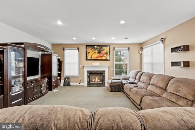 carpeted living room featuring a premium fireplace