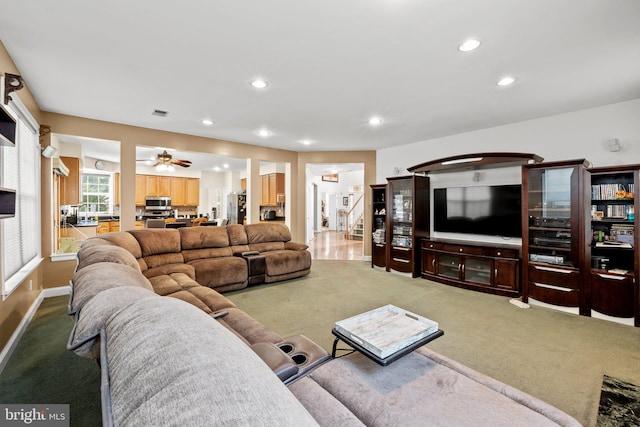 carpeted living room featuring ceiling fan