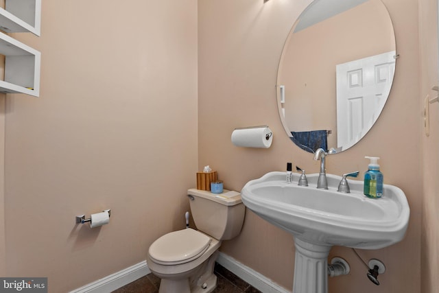 bathroom featuring tile patterned flooring and toilet