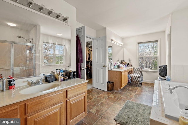 bathroom with vanity and independent shower and bath